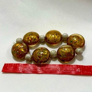 Brown/green/gold spotted discs, stretchy bracelet